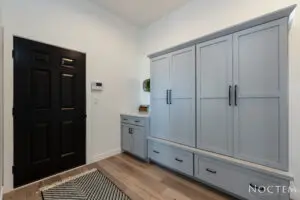 A room with black door and white wardrobes