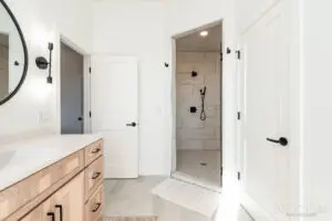A room with two white doors and an attached bathroom