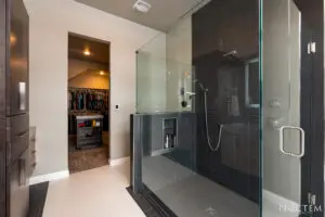 Luxury washroom with glass wall and attached changing room