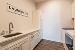 Laundry area with a sink and washing machines