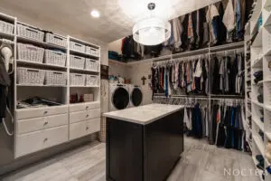 Laundry room with clothes hanged and a table in the center