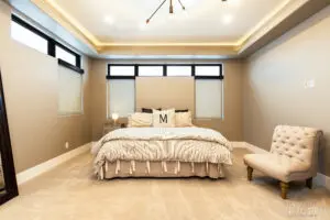 Bedroom with king size bed and a chair