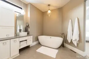 Bathroom with bathtub, towels hanging and a wash basin