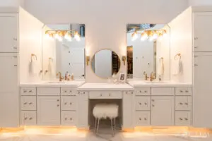 A bathroom with two sinks and three mirrors.
