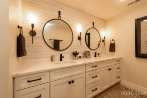 A bathroom with two sinks and mirrors in it