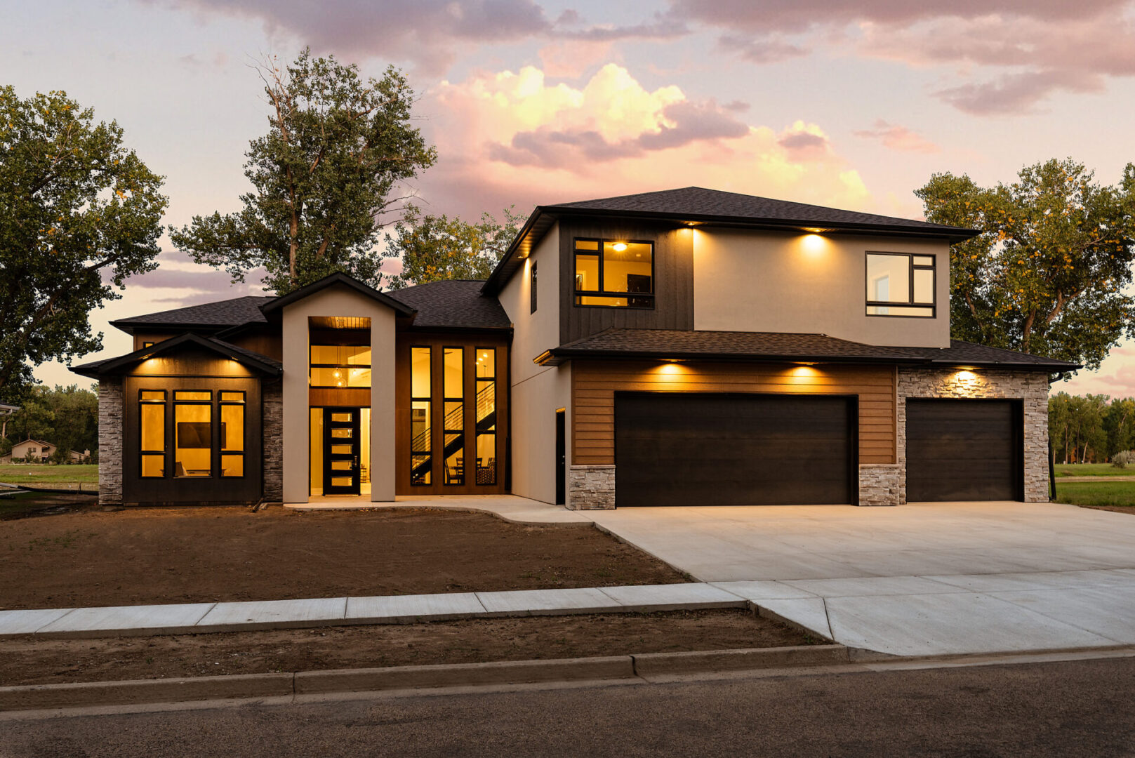 A large modern home with a driveway and garage.