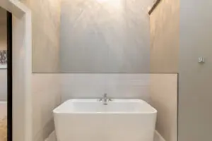 A white bath tub sitting in the middle of a bathroom.