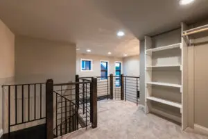 A room with stairs and shelves in it