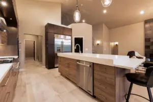 A kitchen with a large island and stainless steel appliances.