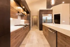 A kitchen with wooden cabinets and white counters.