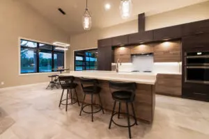 A kitchen with a large island and bar stools.