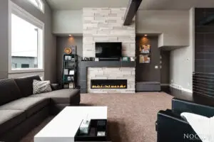 A living room with a fireplace and a flat screen tv.
