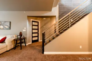A room with stairs and a desk in it