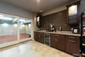 A kitchen with a brick wall and tile floor.