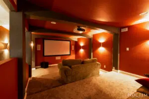 A living room with a couch and a projector screen