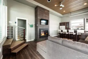 A living room with a fireplace and wooden floors