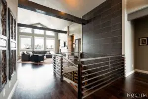 A room with wood floors and a metal railing.