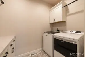 A kitchen with white cabinets and appliances in it