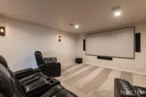 A room with a projector screen and a couch