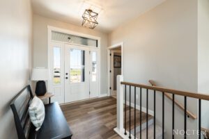 Modern entryway with white door and bench.