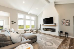 Living room with fireplace and large windows.