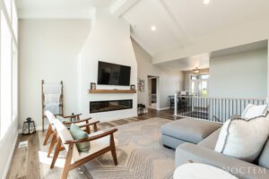 Modern living room with fireplace and large window.