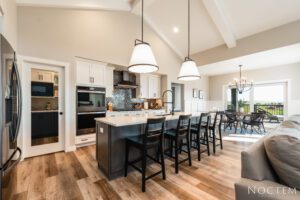 Modern kitchen with island and bar stools.