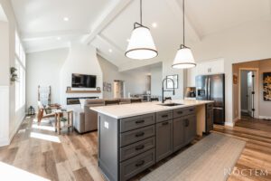 Kitchen island with white countertop and gray cabinets.