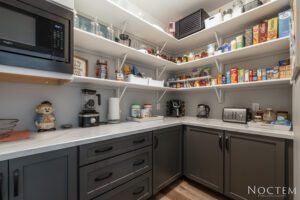 Organized pantry with shelves and appliances.