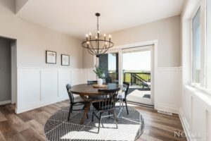 Dining room with chandelier and patio view.