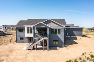 Gray house with deck and stairs.