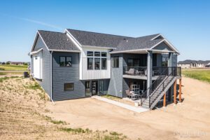 Modern gray house with a deck and stairs.